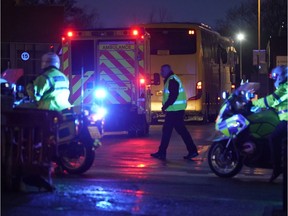 WIRRAL, MERSEYSIDE - FEBRUARY 22: An ambulance and police are seen as coaches containing British Diamond Princess evacuees arrive at Arrowe Park Hospital on February 22, 2020 in Wirral, United Kingdom. UK nationals who have spent 16 days in quarantine on the coronavirus-hit Diamond Princess cruise liner have been repatriated after testing negative for the virus. After landing in the UK, the group will spend 14 days quarantined at Arrowe Park Hospital in the Wirral.