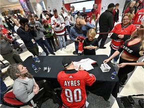 A long line of fans waited for autographs from Dave Ayres signs autographs during Tuesday's game between the Dallas Stars and Carolina Hurricanes in Raleigh, N.C.