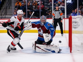 Colorado Avalanche goaltender Philipp Grubauer makes a save against Ottawa Senators centre Colin White during Tuesday's game in Denver.