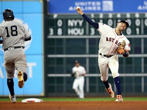 Oct. 19, 2019: Houston Astros shortstop Carlos Correa (1) turns a double play during the eighth inning against the New York Yankees in game six of the 2019 ALCS playoff baseball series at Minute Maid Park.