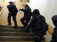 Members of the Regina Police Service SWAT unit take part in a drill at a vacant school in the city.