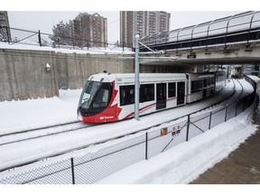 Trains travel the Confederation Line of the Ottawa LRT system at Lees Station.