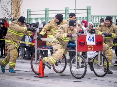 An Ottawa firefighter deftly avoids a pylon during the modified bed race on York Street on Saturday.