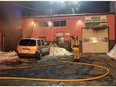 Ottawa Fire Services crews battling a fire at 457-461 Gladstone Ave. in the Centretown neighbourhood on the evening of Saturday, Feb. 15, 2016. The fire was in a one-storey building housing two automotive businesses. Scott Stilborn photo/Twitter.