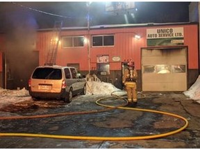 Ottawa Fire Services crews battling a fire at 457-461 Gladstone Ave. in the Centretown neighbourhood on the evening of Saturday, Feb. 15, 2016. The fire was in a one-storey building housing two automotive businesses. Scott Stilborn photo/Twitter.