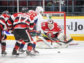 Cedrick Andree of the Ottawa 67's is ready for a shot from Cole Purboo of the Windsor Spitfires at The Arena at TD Place on Sunday.