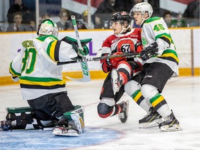 A file photo shows the Ottawa  67's Jack Beck (19) getting an unfriendly welcome from the London Knights' Brett Brochu (30) and Gerard Keane (45) in a game in February 2020.