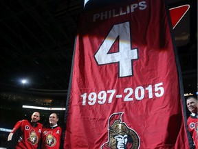 Chris Phillips (seen here with former teammate Craig Anderson, left) had his #4 jersey retired to the rafters Tuesday at Canadian Tire Centre before the Ottawa Senators faced off against the Buffalo Sabres.