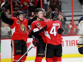 From left: Drake Batherson, Brady Tkachuk and J.G. Pageau celebrate Pageau's goal that made it 6-4 in the third period as their former teammate, Curtis Lazar, skates past during the Ottawa Senators' matchup against the Buffalo Sabres Tuesday night (Feb 18, 2020) at the Canadian Tire Centre.