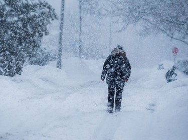 A man walks through a heavy snowfall in Ottawa.