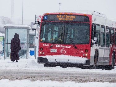 An OC Transpo bus out of service exiting Carlingwood Mall during a heavy snowfall in Ottawa. February 27, 2020.