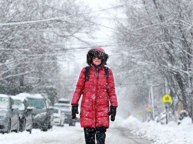 Alexandra Opar is forced to walk down the middle of Fourth Avenue because "there's nowhere else to walk," she said, as the city's snowplough crews tried to catch up with the almost 20 centimetres of snow that continued all day Thursday.