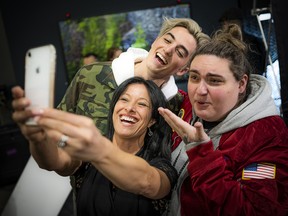 Lina Caruso, executive assistant with Star Motors of Ottawa, takes a selfie with Elijah Woods x Jamie Fine.