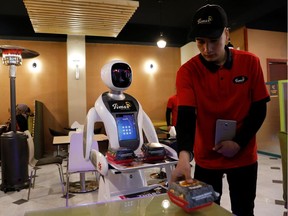 A waitress robot (Timea) delivers food to a table at the Times Fast Food restaurant in Kabul, Afghanistan February 11, 2020.