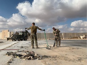 (FILES) A file picture taken on January 13, 2020 during a press tour organized by the US-led coalition fighting the remnants of the Islamic State group, shows US soldiers clearing rubble at Ain al-Asad military airbase in the western Iraqi province of Anbar. - Nearly three dozen US troops suffered traumatic brain injuries or concussion in the recent Iranian air strike on a military base in Iraq housing American personnel, the Pentagon said on January 24, 2020. "Thirty-four total members have been diagonosed with concussions and TBI (traumatic brain injury)," Pentagon spokesman Jonathan Hoffman told reporters.