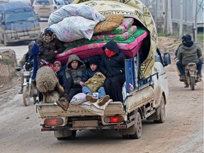 Displaced Syrians flee the countryside of Aleppo and Idlib provinces towards Syria's northwestern Afrin district near the border with Turkey on February 13, 2020, as regime forces push on with their offensive in the country's northwest.