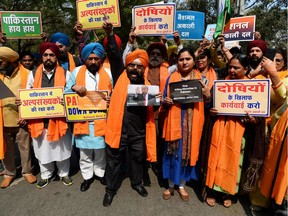 National Akali Dal President Paramjit Singh (C) shouts slogans along with party supporters during a protest to demand US President Donal Trump to take action against Pakistan, in New Delhi on February 23, 2020, ahead of Trump's first oficial visit to India. (Photo by Sajjad HUSSAIN / AFP)