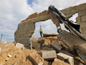 A member of the Palestinian Islamic Jihad militant group inspects a site, targeted by an Israeli airstrike the day before for reportedly being a training ground for the group, in Gaza City on February 25, 2020.