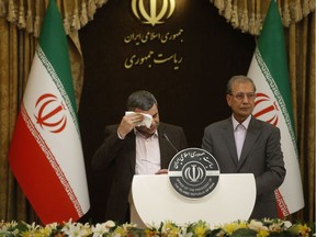 Iranian Deputy Health Minister Iraj Harirchi (L) wipes the sweat off his face, during a press conference with the Islamic republic's government spokesman Ali Rabiei in the capital Tehran on February 24, 2020. - Iran's deputy health minister confirmed on February 25, that he has tested positive for the novel coronavirus, amid a major outbreak in the Islamic republic. Harirchi coughed occasionally and appeared to be sweating during the press conference with Rabiei in Tehran.