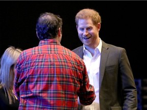 Britain's Prince Harry (R), Duke of Sussex, greets delegates as he attends a sustainable tourism summit at the Edinburgh International Conference Centre in Edinburgh on February 26, 2020. - Prince Harry was back in Britain on February 26 for the first of a final round of public appearances before he and his wife Meghan step back from their royal duties.