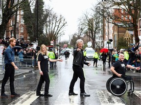 Files: Britain's Prince Harry, Duke of Sussex (L), US singer Jon Bon Jovi (2R) and two members of the Invictus Games Choir walk on the famous zebra crossing that The Beetles walked across, outside Abbey Road Studios in London on February 28, 2020, where they were to record a special single in aid of the Invictus Games Foundation