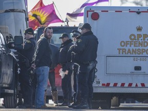 Uniformed OPP officers arrested protesters on the 19th day of a demonstration at the level Wymans Road CN rail crossing around 8 a.m. Monday.