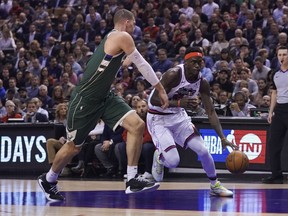 Raptors forward Pascal Siakam tries to get around Bucks centre Brook Lopez during the first half of Tuesday's game in Toronto.