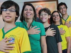 Members of the da Silva family, (L-R) Bernardo de Assis, Silvia Santos da Silva, Pedro de Assis, Silvana Santos da Silva, and Joao de Assis, pose for a photo showing their hands all have six fingers, in Brasilia, June 20, 2014.