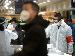 Customers wearing face masks shop inside a supermarket following an outbreak of the novel coronavirus in Wuhan, Hubei province, China February 10, 2020.
