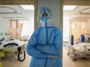 A medical worker in protective suit takes a break at an isolated ward of Wuhan Red Cross Hospital in Wuhan, the epicentre of the novel coronavirus outbreak, in Hubei province, China February 16, 2020. Picture taken February 16, 2020.