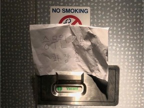 A photo of the handwritten sign saying "lavatory for crew members only" is pictured on a flight KL855 from Amsterdam to Seoul's Incheon airport, February 10, 2020 in this picture obtained by Reuters from social media on February 14, 2020.