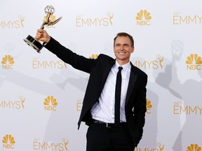 FILE PHOTO: Phil Keoghan poses with his Outstanding Reality-Competition Program award for the CBS show "The Amazing Race" at the 66th Primetime Emmy Awards in Los Angeles, California August 25, 2014.