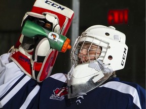 A goalie with the Ottawa Jr. Senators takes a sports drink during a Central Canada Hockey League game in March 2019.