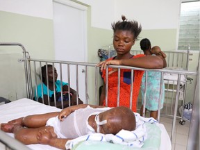 Dorvil Chiloveson, 3, swollen with edema, is watched over by his mother Linda Julien, 20, in the malnutrition ward at St. Damien Pediatric Hospital in Port-au-Prince, Haiti January 29, 2020. Picture taken January 29, 2020.