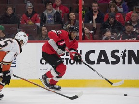 Ottawa Senators left wing Anthony Duclair shoots the puck away from Anaheim Ducks right wing Ondrej Kase in the first period at the Canadian Tire Centre on Feb. 4, 2020.