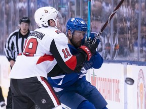 Ottawa Senators right wing Drake Batherson battles for the puck with Toronto Maple Leafs center Frederik Gauthier during the first period at the Scotiabank Arena on Saturday.