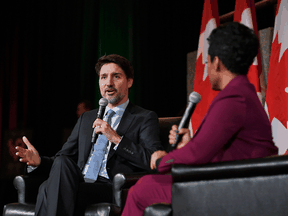 Prime Minister Justin Trudeau speaks with broadcast journalist Marci Ien at a Black History Month reception at the National Arts Centre in Ottawa, on Monday.