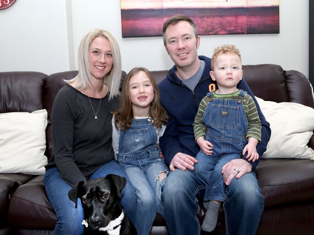 Ryan Bennett and his wife, Sarah, with their children, Shelby, 6, and Kallan, 22 months, along with family dog Luna in their Kingston home on Thursday.
