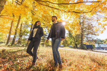 Couple walking among fall colours at year-round Wheelers Pancake House.