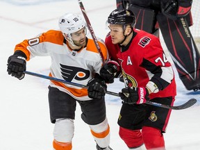 Ottawa Senator Mark Borowiecki battles with Philadelphia Flyers Andy Andreoff during NHL action at the Canadian Tire Centre on Saturday December 21,2019.