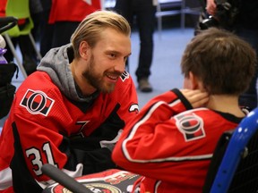 Senators goaltender Anders Nilsson meets a young Sens fan at the team’s annual Christmas CHEO holiday visit.