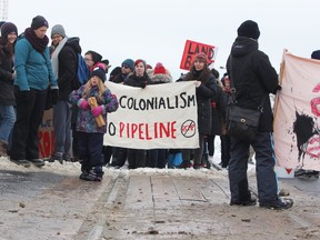 Demonstrators against the Coastal GasLink pipeline that crosses the WetÕsuwetÕen territory in British Columbia show their support by blocking the CN tracks in Kingston, Ont., on Sunday, February 9, 2020.