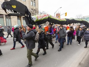 A large protest took over Dundas Street as it left Wellington went up Richmond then down Queens on the way to the RCMP offices on Talbot Street in London, Ont. A large snake representing a pipeline carries signs that the pipeline is not worth it in terms of health and pollution. They were protesting in solidarity with the Wet'suwet'en Nation who are blockading the Coastal GasLink pipeline in BC Photograph taken on Tuesday February 11, 2020.