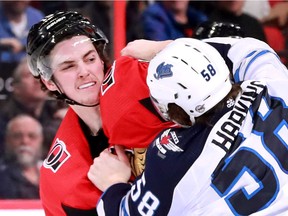 Ottawa's Drake Batherson (19) drops the gloves against Jansen Harkins (58) near the end of the first period action between the Ottawa Senators and the Winnipeg Jets on Thursday, Feb. 20, 2020  at Canadian Tire Centre. Julie Oliver/Postmedia