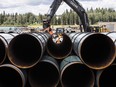 Pipe for the Trans Mountain pipeline is unloaded in Edson, Alta. on Tuesday, June 18, 2019.