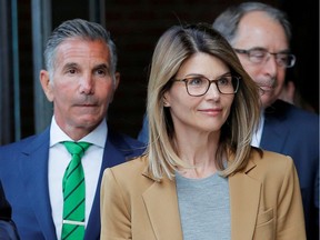 FILE PHOTO: Actor Lori Loughlin, and her husband, fashion designer Mossimo Giannulli, leave the federal courthouse after facing charges in a nationwide college admissions cheating scheme, in Boston, Massachusetts, U.S., April 3, 2019.