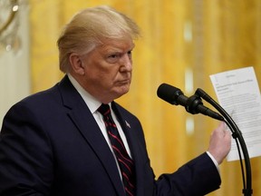 U.S. President Donald Trump responds to a question about Ukraine and the whistleblower report while holding a news story from the New York Times during a joint news conference with Finland's President Sauli Niinisto at the White House in Washington, U.S., October 2, 2019.
