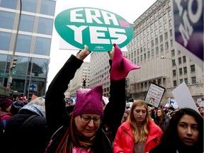 FILE PHOTO: A demonstrator holds a sign calling for an equal rights amendment (ERA) during in the Third Annual Women's March at Freedom Plaza in Washington, U.S., January 19, 2019