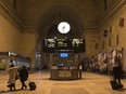 People make their way through Union Station in Toronto as the departure display for Via Rail show all trains have been cancelled on Feb. 13, 2020.