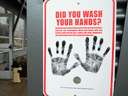 A sign reminding people to wash their hands outside a dormitory designated as a 2019 novel coronavirus quarantine site in North Bend, Washington.
